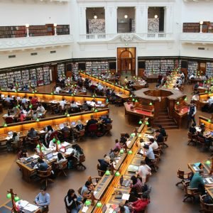 Aerial view of a bustling study hall in a university library with students studying.
