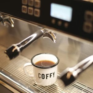 Close-up of a Cup of Coffee Standing on a Coffee Machine