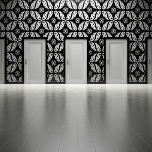 Five closed doors in a black and white ornate hallway symbolizing opportunities and decisions.