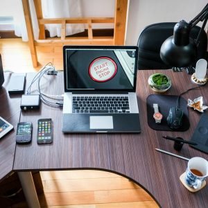 A contemporary office desk setup with laptops, gadgets, and accessories, creating a tech-savvy workplace.