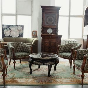 A charming vintage room featuring elegant antique furniture and decor.