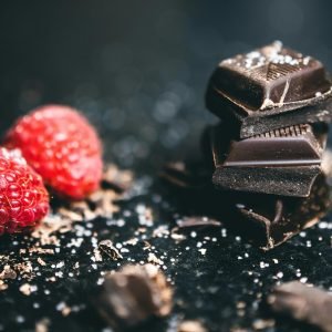 Close-up of dark chocolate pieces and raspberries, perfect for gourmet dessert ideas.