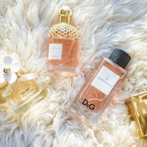 Elegant collection of perfume bottles on soft fur, highlighting luxury and style.